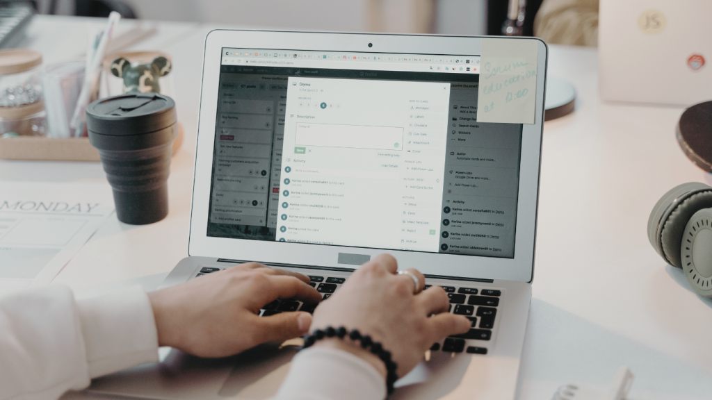 Hands typing on a laptop showing an email inbox